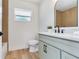 Stylish bathroom featuring shaker cabinets, granite countertop, modern fixtures, mirror, and decorative wood accent wall at 7500 16Th N St, St Petersburg, FL 33702