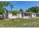 Charming single-story home featuring a freshly painted exterior, well-maintained lawn, and inviting curb appeal at 7500 16Th N St, St Petersburg, FL 33702