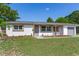 Charming one story home featuring a covered entry and an attached one car garage at 7500 16Th N St, St Petersburg, FL 33702