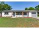 Charming one story home featuring a covered entry and an attached one car garage at 7500 16Th N St, St Petersburg, FL 33702