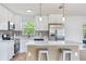 Bright kitchen featuring stainless appliances, quartz countertops, modern fixtures and a view of the backyard at 7500 16Th N St, St Petersburg, FL 33702