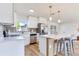 Bright kitchen featuring stainless appliances, quartz countertops, and a modern island with bar seating at 7500 16Th N St, St Petersburg, FL 33702