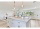 Bright open living space showcases an island kitchen and a cozy seating area by large windows at 7500 16Th N St, St Petersburg, FL 33702