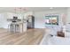 View of kitchen island and open living space with sliding doors to backyard and comfortable seating area at 7500 16Th N St, St Petersburg, FL 33702