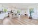 Bright, open-concept living space featuring light floors, a kitchen island and a view into the living room at 7500 16Th N St, St Petersburg, FL 33702