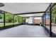 Spacious screened-in patio with overhead cover, room for seating, and view of backyard at 7500 16Th N St, St Petersburg, FL 33702