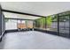 Large screened-in patio featuring concrete flooring, patio furniture, and clear backyard views at 7500 16Th N St, St Petersburg, FL 33702