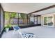 Comfortable, furnished patio featuring tiled flooring, backyard views, and a screened enclosure at 7500 16Th N St, St Petersburg, FL 33702