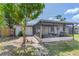 An outdoor screened patio with seating, accessible from the backyard, providing an outdoor living space at 7500 16Th N St, St Petersburg, FL 33702