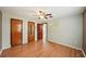 Spacious bedroom featuring laminate flooring, closet space, ceiling fan, and natural light at 7511 N Ola Ave, Tampa, FL 33604