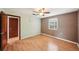 This bedroom offers wood-look floors, natural light, and a ceiling fan at 7511 N Ola Ave, Tampa, FL 33604