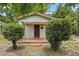 Charming single-story home featuring a brick porch and neatly trimmed shrubbery in the front yard at 7511 N Ola Ave, Tampa, FL 33604
