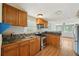 View of kitchen with stainless steel appliances, wooden cabinets, and view of living room at 7511 N Ola Ave, Tampa, FL 33604