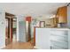 Kitchen with stainless steel appliances, hardwood flooring, and seamless access to adjacent rooms at 7511 N Ola Ave, Tampa, FL 33604