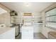 Functional laundry room with shelving, appliances, and a window providing natural light at 7511 N Ola Ave, Tampa, FL 33604