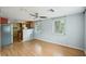 Inviting living room with hardwood floors, flowing to the kitchen with stainless steel appliances at 7511 N Ola Ave, Tampa, FL 33604