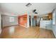 Open-concept living space featuring hardwood floors and seamless flow into the adjacent kitchen at 7511 N Ola Ave, Tampa, FL 33604