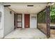 Covered patio featuring string lights, two exterior doors, and privacy screens at 7511 N Ola Ave, Tampa, FL 33604