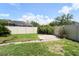 Large backyard with manicured lawn, patio, and privacy fence, great for outdoor entertaining at 10219 Millport Dr, Tampa, FL 33626