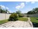 Landscaped backyard featuring a small patio area and surrounding garden at 10219 Millport Dr, Tampa, FL 33626