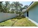 Fenced backyard with well-kept lawn and mature trees offering shade at 10219 Millport Dr, Tampa, FL 33626