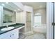 Bathroom featuring a soaking tub, glass block window and a vanity at 10219 Millport Dr, Tampa, FL 33626
