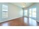 Serene bedroom with wood floors, natural light, and access to the pool area, creating a peaceful retreat at 10219 Millport Dr, Tampa, FL 33626