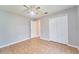 Spacious bedroom features neutral paint, tile flooring, ceiling fan and closet at 10219 Millport Dr, Tampa, FL 33626
