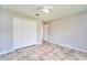 Comfortable bedroom includes a spacious closet, neutral paint, ceiling fan and tile flooring at 10219 Millport Dr, Tampa, FL 33626