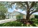 Attractive home featuring a three-car garage, mature landscaping, and a well-maintained lawn, creating great curb appeal at 10219 Millport Dr, Tampa, FL 33626