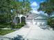 Charming home with a well-maintained lawn, three-car garage, and manicured landscaping at 10219 Millport Dr, Tampa, FL 33626