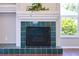 Close up of the fireplace with green tiles at 10219 Millport Dr, Tampa, FL 33626