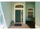 Charming front door with decorative window, sidelight, and tiled porch at 10219 Millport Dr, Tampa, FL 33626