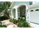 Beautifully landscaped front entrance with arched entry and well-maintained garden at 10219 Millport Dr, Tampa, FL 33626