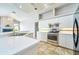 Bright kitchen features modern stainless steel appliances and white cabinetry at 10219 Millport Dr, Tampa, FL 33626