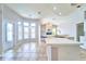 Open kitchen overlooking the Gathering room with a fireplace at 10219 Millport Dr, Tampa, FL 33626