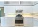 Clean kitchen with white cabinetry and stainless steel gas range at 10219 Millport Dr, Tampa, FL 33626