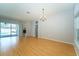 Spacious living room with wood floors, large windows, and access to the pool area, ideal for relaxation and gatherings at 10219 Millport Dr, Tampa, FL 33626