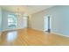 Bright living room with wood floors, large windows, and an open layout, offering versatility and comfort at 10219 Millport Dr, Tampa, FL 33626