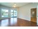Bright living room with wood floors, ceiling fan, and sliding doors to the pool at 10219 Millport Dr, Tampa, FL 33626