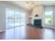 Living room with hardwood floors, fireplace, and view of the pool at 10219 Millport Dr, Tampa, FL 33626