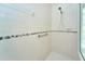 Shower stall with white tile and a hand rail at 10219 Millport Dr, Tampa, FL 33626