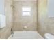 Bathroom with tiled walls and a tub and shower combination at 106 Avery Ave, Crystal Beach, FL 34681
