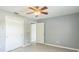 This bedroom has wood-look flooring, a ceiling fan, and gray walls at 106 Avery Ave, Crystal Beach, FL 34681