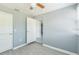 Empty room with gray walls, new light-colored flooring, and multiple doorways to other rooms at 106 Avery Ave, Crystal Beach, FL 34681