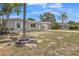 Charming single-story home with light-colored exterior, well-manicured landscaping and a long driveway at 106 Avery Ave, Crystal Beach, FL 34681