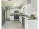 Modern kitchen equipped with stainless steel appliances, granite countertops, and sleek white cabinetry at 106 Avery Ave, Crystal Beach, FL 34681