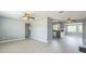 Open-concept living room featuring modern flooring and gray walls, seamlessly connecting to the kitchen at 106 Avery Ave, Crystal Beach, FL 34681