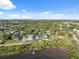 Waterfront homes feature lush landscaping with stunning views of the bay under bright skies at 108 Shore Dr, Tarpon Springs, FL 34689