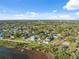 Waterfront homes feature lush landscaping with stunning views of the bay under bright skies at 108 Shore Dr, Tarpon Springs, FL 34689